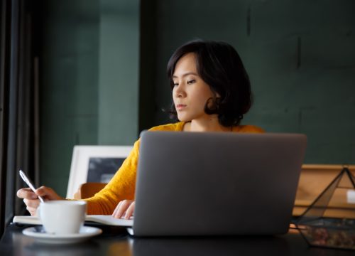 young-business-woman-in-yellow-dress-sitting-at-table-in-cafe-and-writing-in-notebook-student_t20_9lPGJN